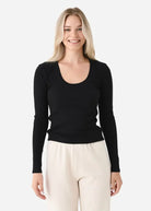 Model wearing the Z Supply Greyson Scoop Long Sleeve featuring a fitted rib knit design with a scoop neckline and long sleeves