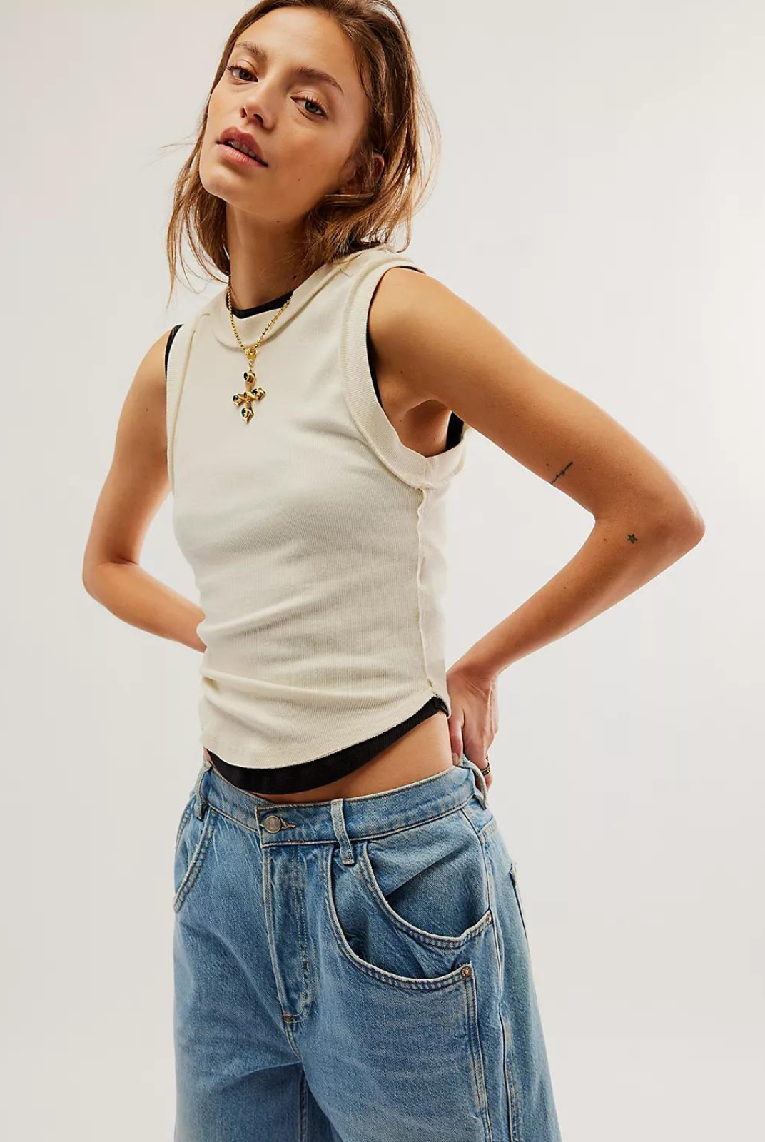 Free People Kate Tee- Ivory The ideal tank-inspired top, this sleeveless tee is featured in an effortless, goes-with-anything design with rounded bottom hem and exposed seaming for a true lived-in look.