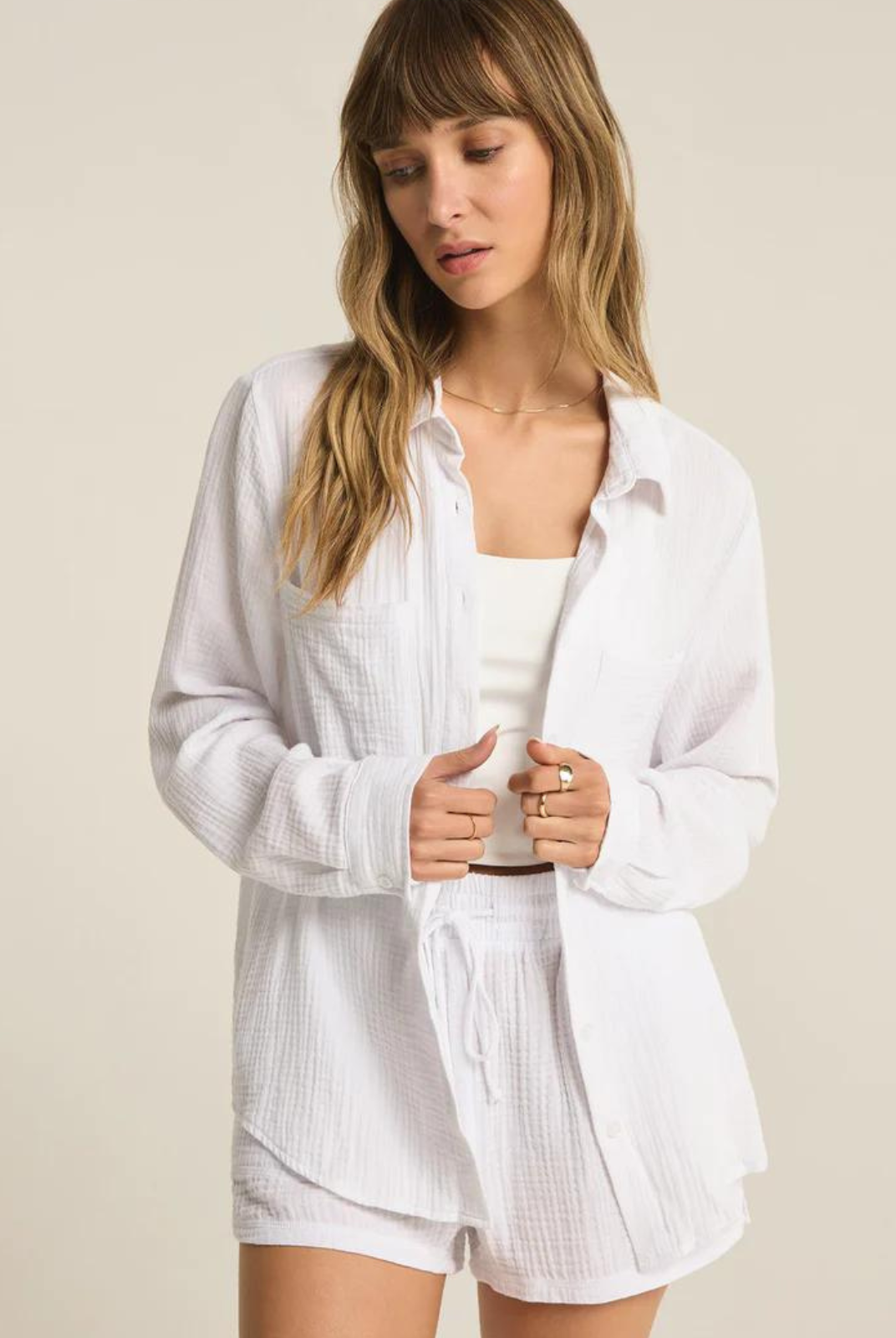 Z Supply Kaili Button Up Gauze Top- White. Meet the dressier side of gauze. This button up gauze top can be worn day to night, and features a relaxed fit with front pockets.